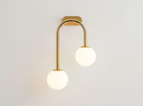 Brass drop curve wall light